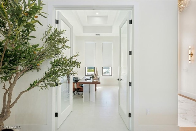 hallway with a tray ceiling