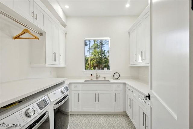 laundry room featuring sink, cabinets, and independent washer and dryer