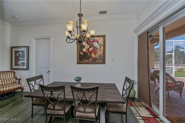 dining area featuring hardwood / wood-style flooring, ornamental molding, and a chandelier