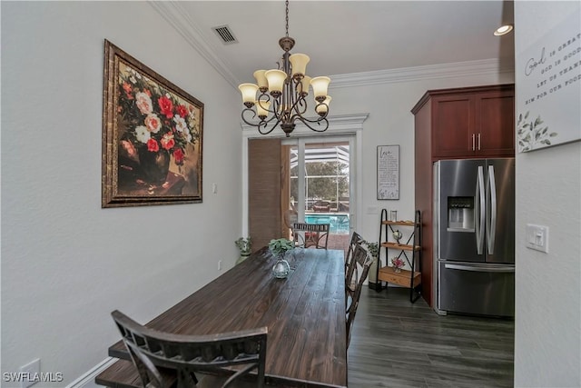 dining room featuring ornamental molding, dark hardwood / wood-style floors, and a notable chandelier