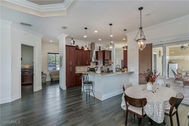 dining area featuring ornamental molding and dark hardwood / wood-style floors