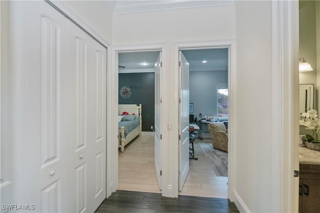 corridor featuring ornamental molding and dark hardwood / wood-style floors