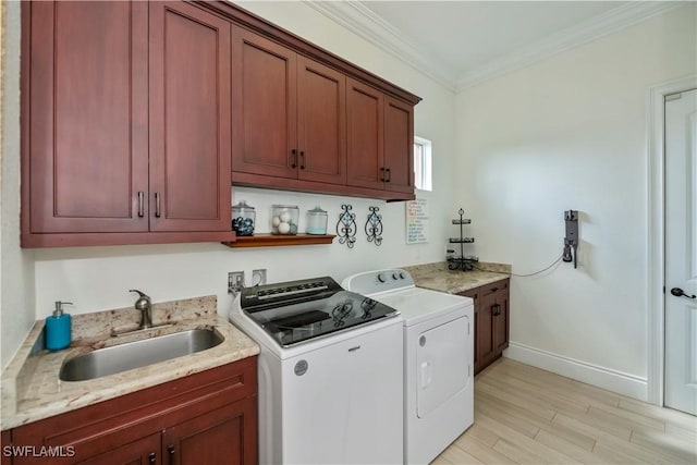 washroom featuring sink, cabinets, ornamental molding, separate washer and dryer, and light wood-type flooring