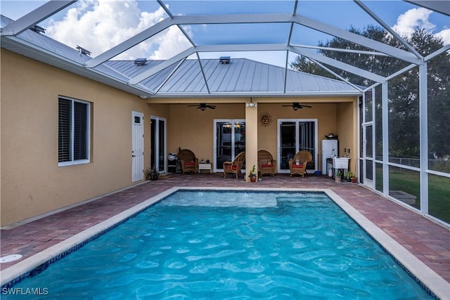 view of pool featuring a lanai, a patio area, and ceiling fan