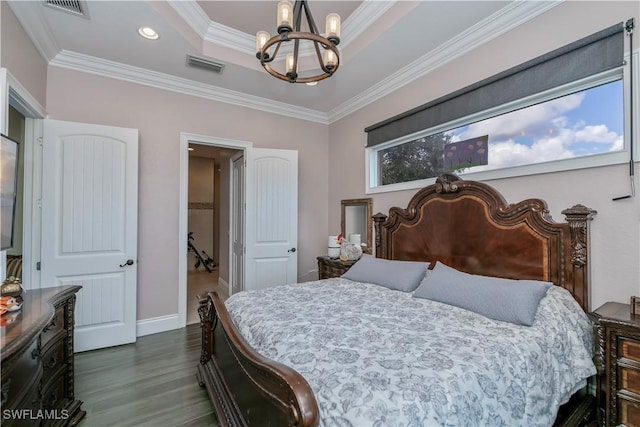 bedroom featuring an inviting chandelier, dark hardwood / wood-style floors, ornamental molding, and a raised ceiling