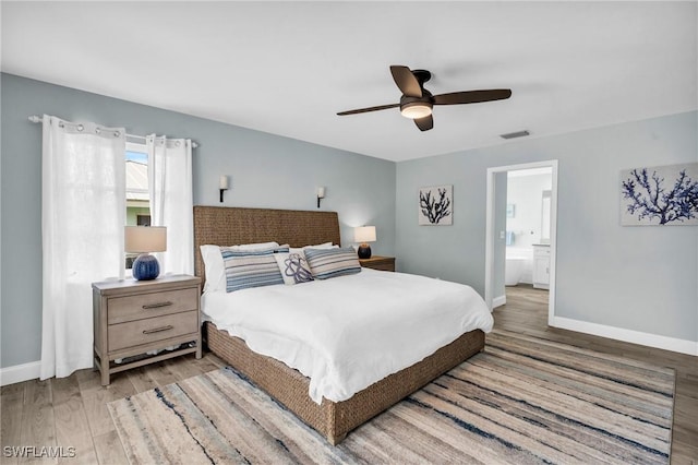 bedroom with connected bathroom, light hardwood / wood-style flooring, and ceiling fan