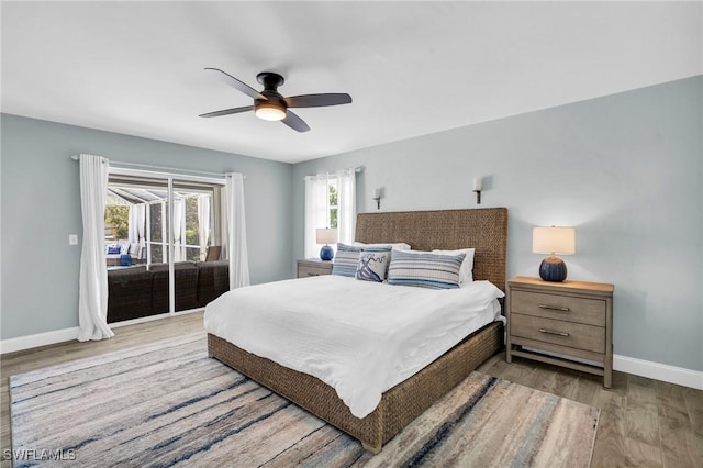 bedroom with access to exterior, light hardwood / wood-style floors, and ceiling fan