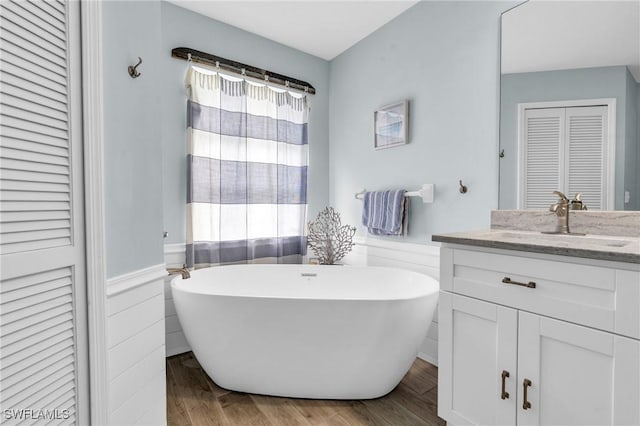 bathroom featuring vanity, a bathtub, and hardwood / wood-style flooring