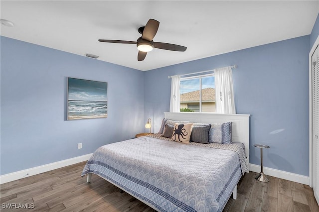 bedroom featuring wood-type flooring, a closet, and ceiling fan