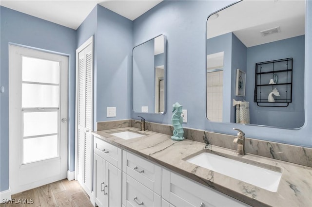 bathroom with vanity and hardwood / wood-style floors