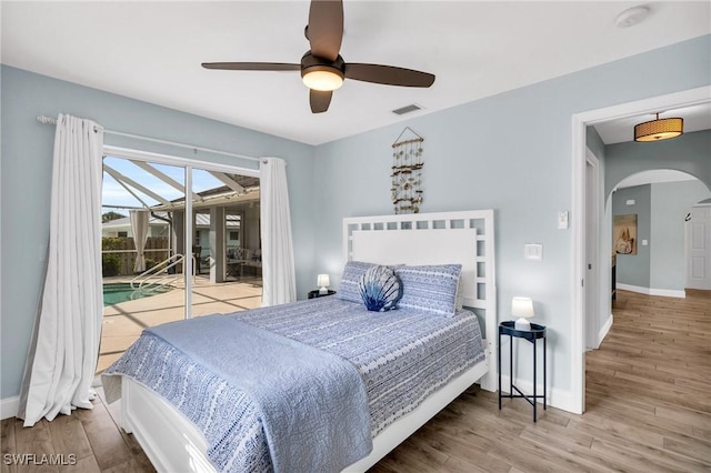 bedroom with hardwood / wood-style flooring, ceiling fan, and access to exterior