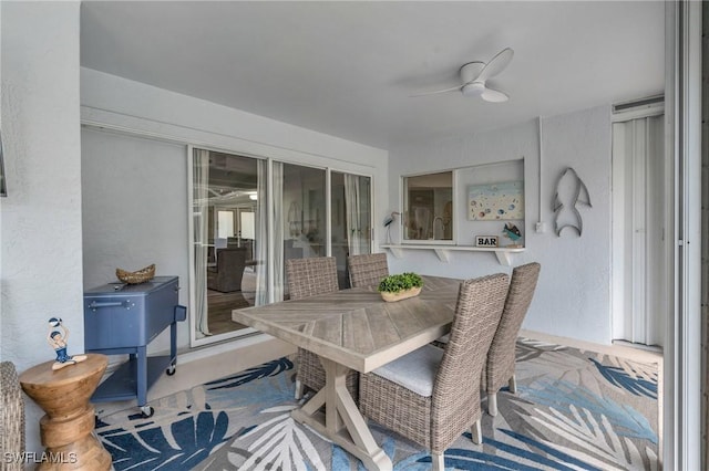 sunroom / solarium featuring ceiling fan