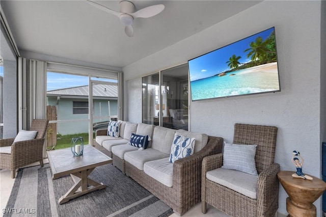 living room with ceiling fan and a wealth of natural light