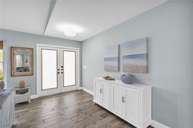 foyer entrance featuring french doors and light hardwood / wood-style flooring