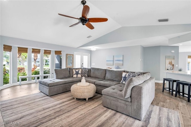 living room featuring french doors, lofted ceiling, ceiling fan, and light hardwood / wood-style flooring