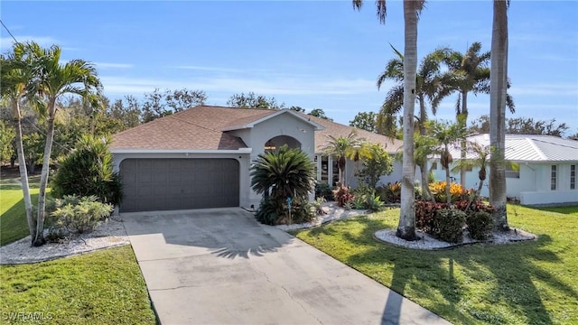 ranch-style house featuring a garage and a front lawn