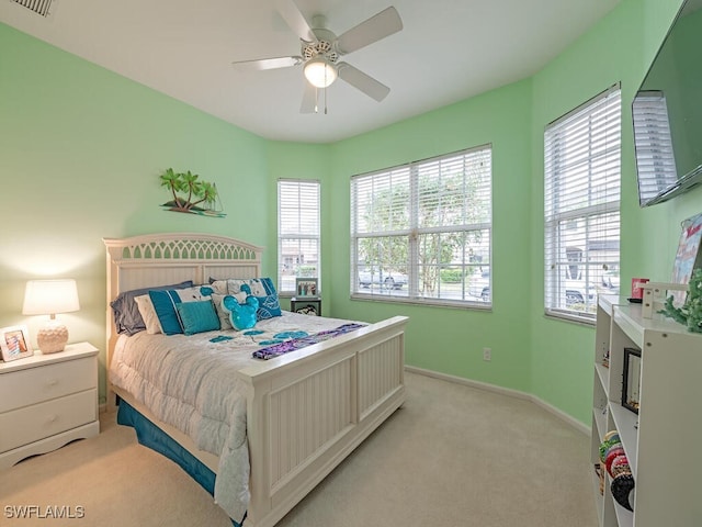 bedroom featuring light carpet and ceiling fan