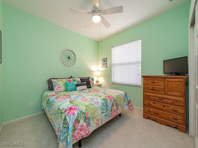 bedroom with light colored carpet and ceiling fan