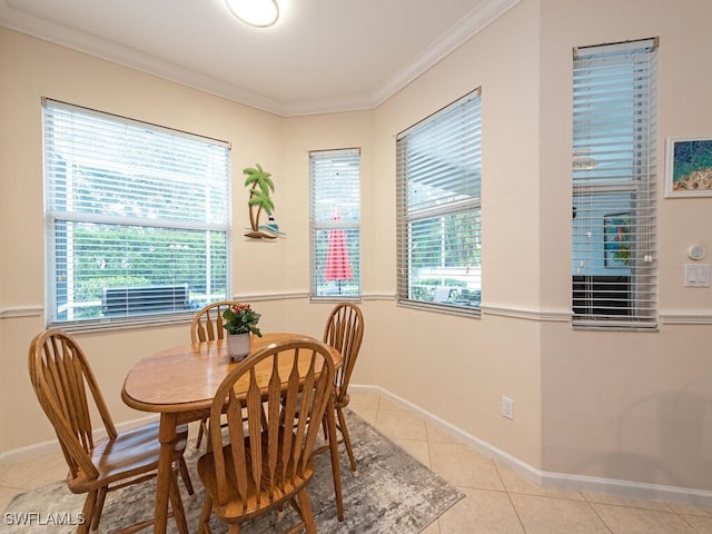 dining space with ornamental molding and light tile patterned flooring