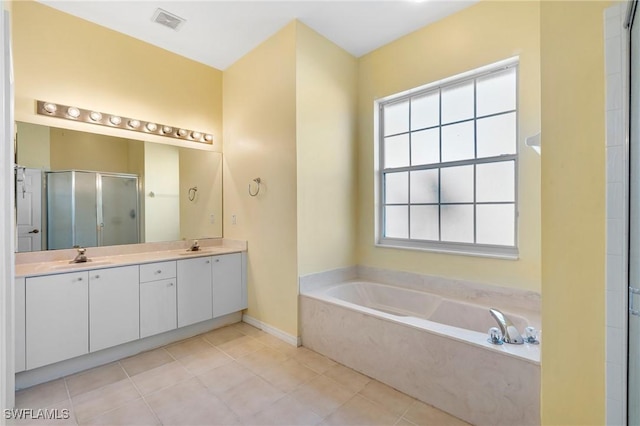 bathroom featuring vanity, shower with separate bathtub, and tile patterned flooring