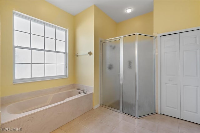 bathroom featuring tile patterned flooring and plus walk in shower