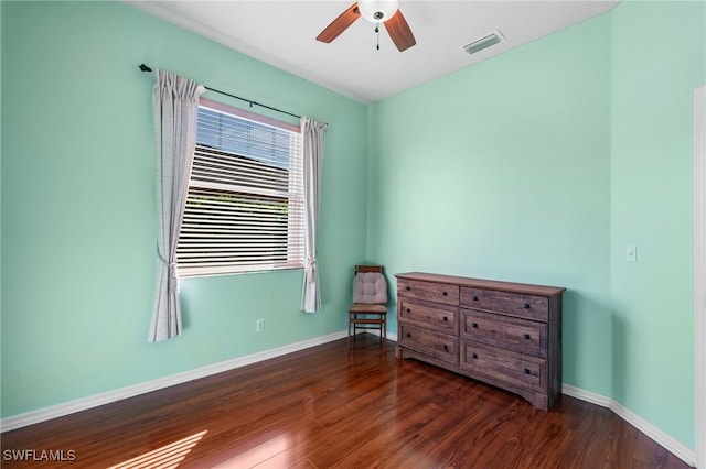 unfurnished bedroom featuring dark wood-type flooring and ceiling fan