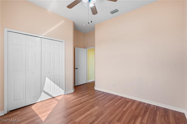 unfurnished bedroom with ceiling fan, light hardwood / wood-style floors, and a closet