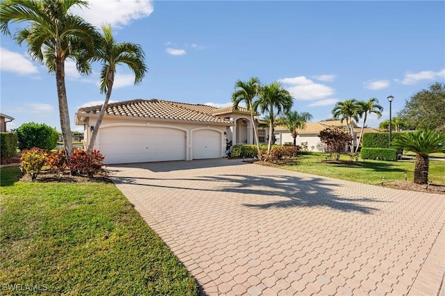 view of front of property featuring a garage and a front yard