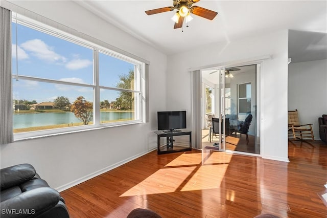 living room featuring hardwood / wood-style flooring and ceiling fan