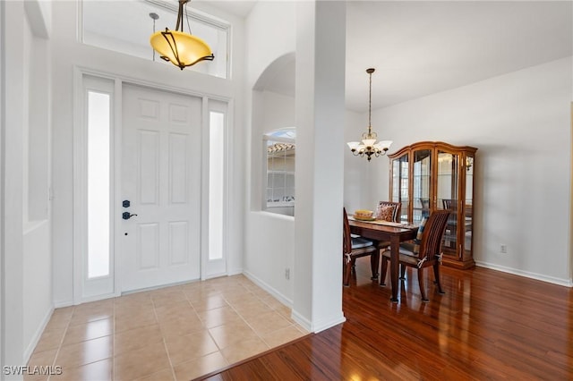 foyer featuring a wealth of natural light, a chandelier, and light hardwood / wood-style floors