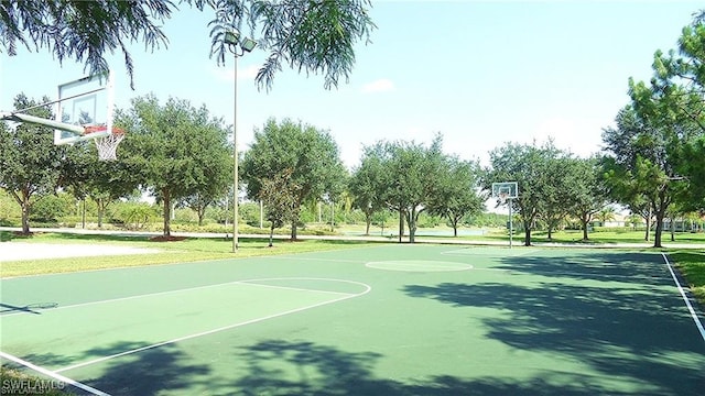 view of sport court with a lawn