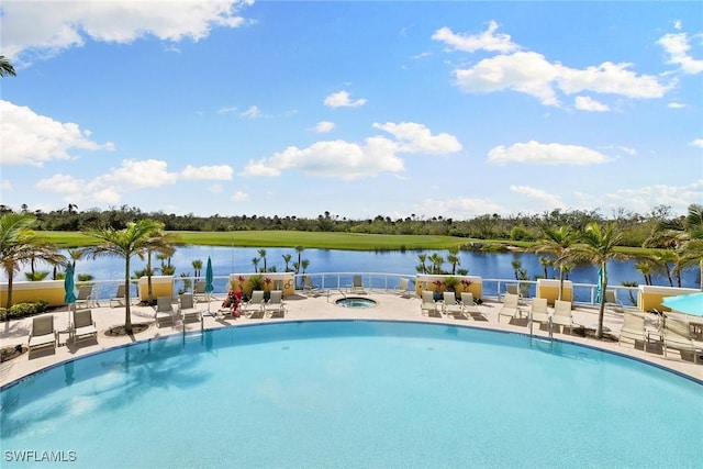 view of swimming pool featuring a water view and a patio area