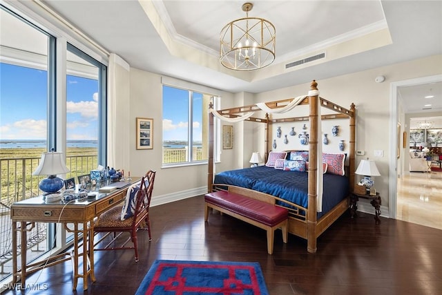 bedroom with crown molding, dark hardwood / wood-style flooring, and a tray ceiling