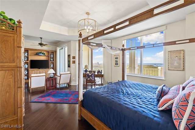 bedroom with multiple windows, crown molding, dark wood-type flooring, and a tray ceiling