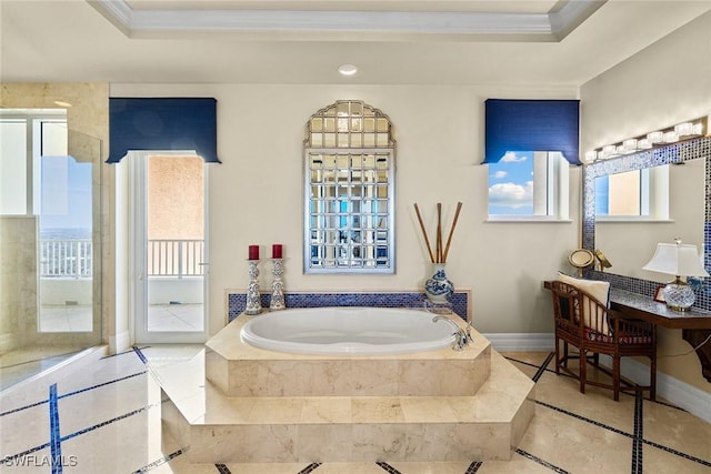 bathroom featuring a relaxing tiled tub, crown molding, and a raised ceiling