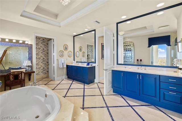 bathroom with vanity, a tray ceiling, tile patterned floors, and a tub