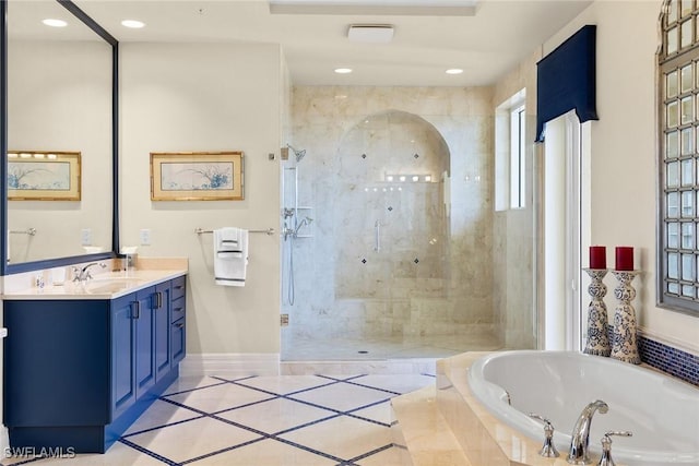 bathroom featuring vanity, shower with separate bathtub, and tile patterned flooring