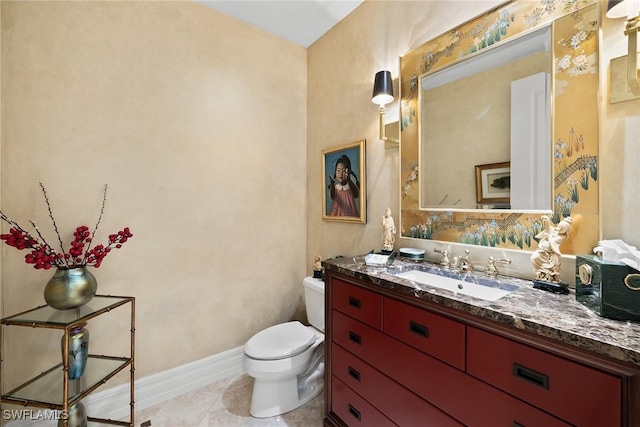 bathroom featuring tile patterned flooring, vanity, and toilet