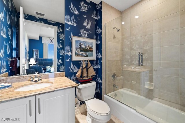 4751 W Bay Blvd Unit 2002, Estero, FL 33928 - full bathroom with combined bath / shower with glass door, wallpapered walls, toilet, vanity, and visible vents