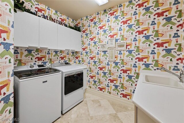 4751 W Bay Blvd Unit 2002, Estero, FL 33928 - laundry area featuring washer and clothes dryer, cabinet space, wallpapered walls, and a sink