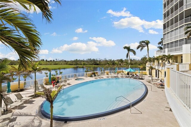 4751 W Bay Blvd Unit 2002, Estero, FL 33928 - pool with a patio area, a water view, and a hot tub