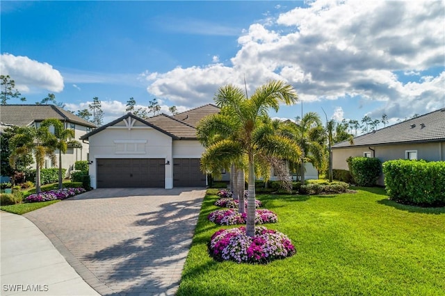 view of front of property with a garage and a front yard