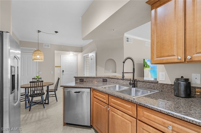 kitchen featuring stone countertops, sink, crown molding, and appliances with stainless steel finishes