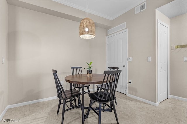 tiled dining room featuring ornamental molding