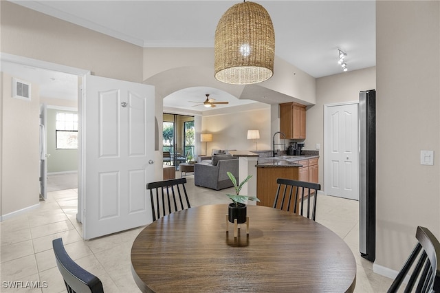 dining room featuring sink, a wealth of natural light, and light tile patterned floors