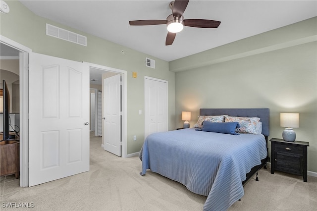 bedroom with light colored carpet, a closet, and ceiling fan