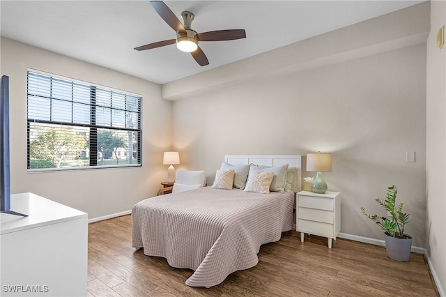 12936 Violino Ln Unit 108, Naples, FL 34105 - bedroom featuring wood finished floors and ceiling fan