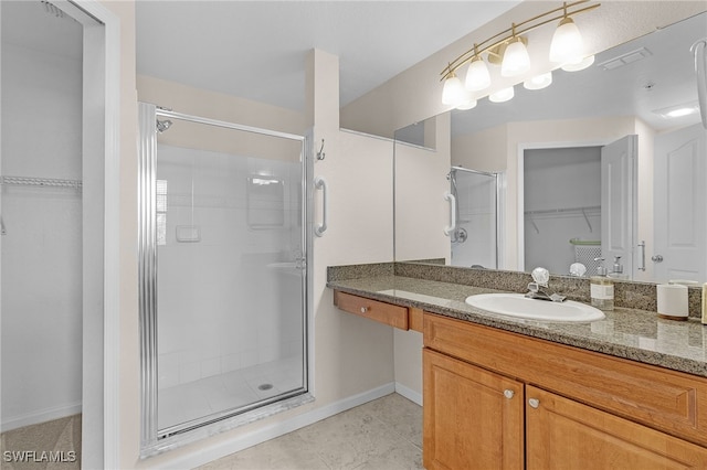 bathroom featuring vanity, tile patterned flooring, and a shower with door