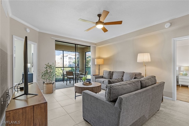 tiled living room featuring ornamental molding and ceiling fan