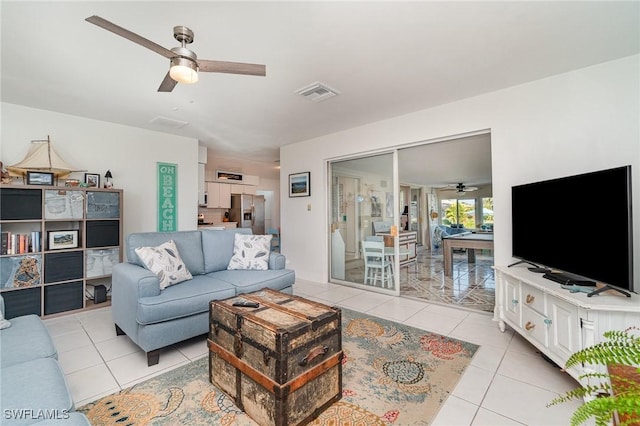 living room featuring ceiling fan and light tile patterned floors